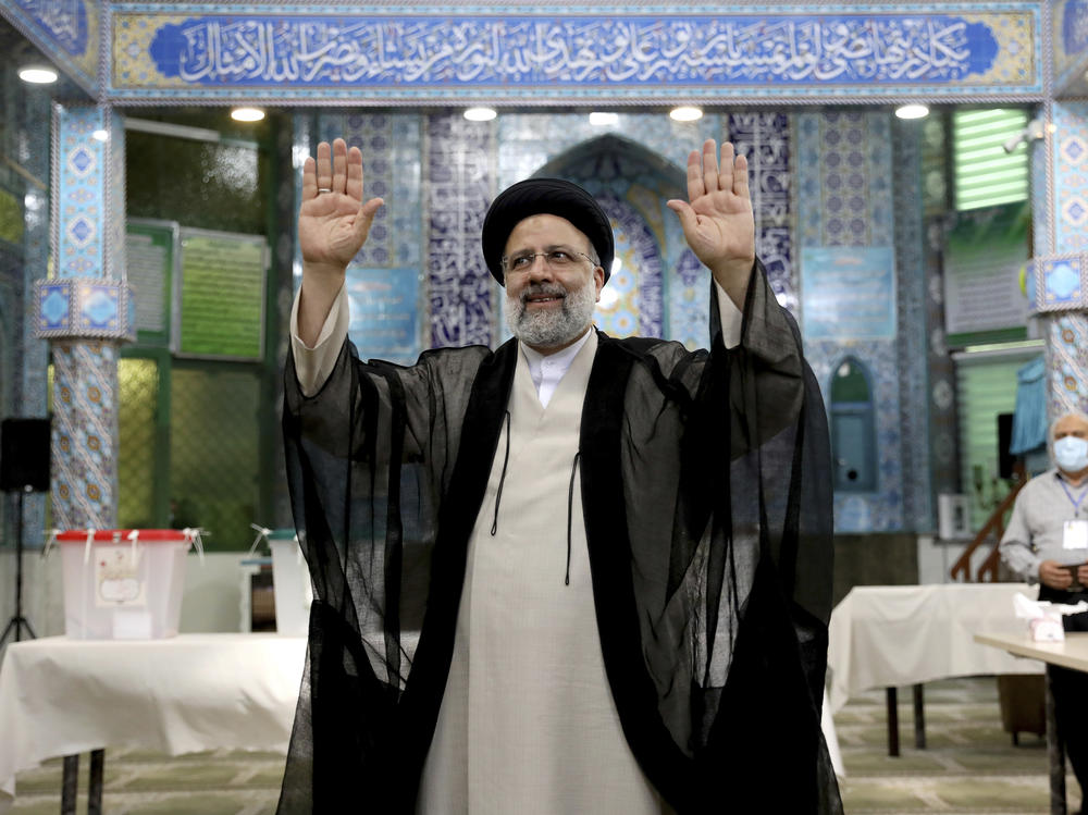 Ebrahim Raisi, a candidate in Iran's presidential elections waves to the media after casting his vote at a polling station in Tehran on Friday.