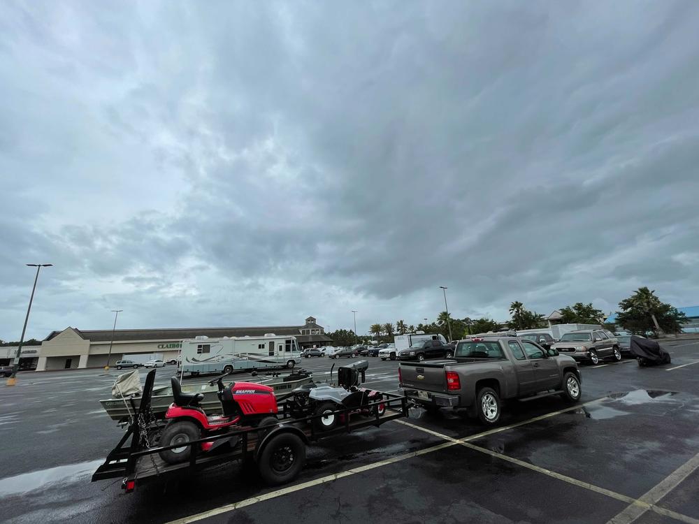 Residents in low-lying areas of Hancock County move their vehicles, lawn mowers, ATVs and boats to higher ground in Waveland, Miss., as a tropical system approaches on Friday.