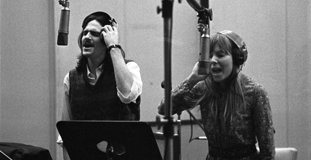 Joni Mitchell (right) and James Taylor singing at A&M Records Recording Studio, during the recording sessions that produced Carole King's 1971 album <em>Tapestry</em>. <em></em>Mitchell was making <em>Blue</em>, to which Taylor also contributed<em></em>, in a studio down the hall.