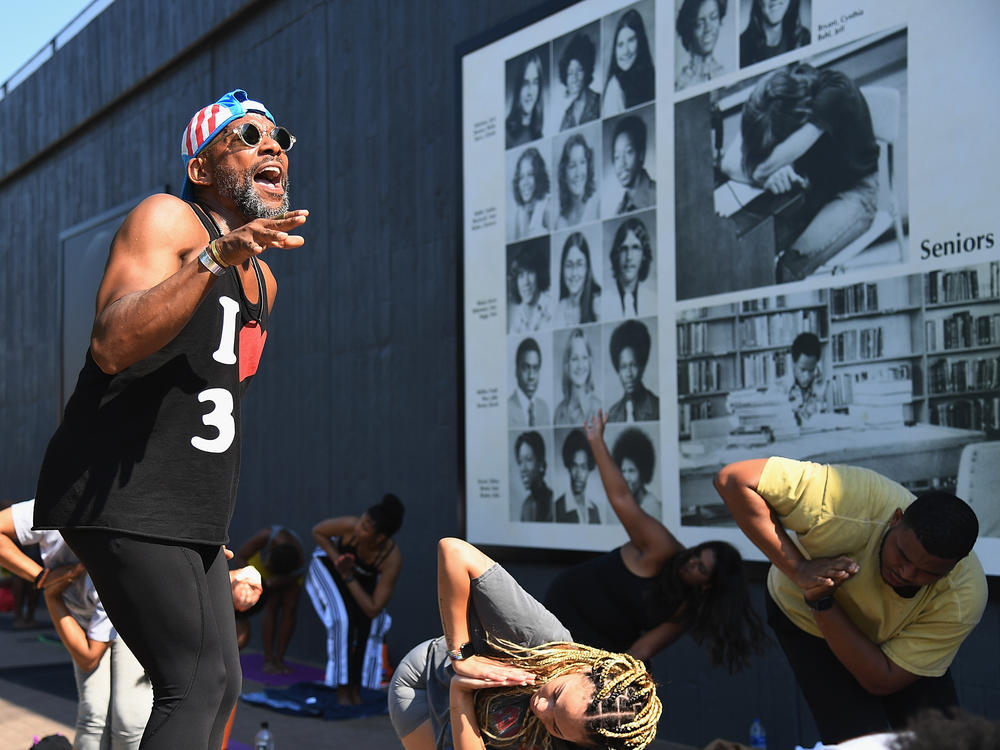 Marlon F. Hall leads a yoga class next to Interstate 244, which runs through the Tulsa neighborhood of Greenwood, the location of the <a href=