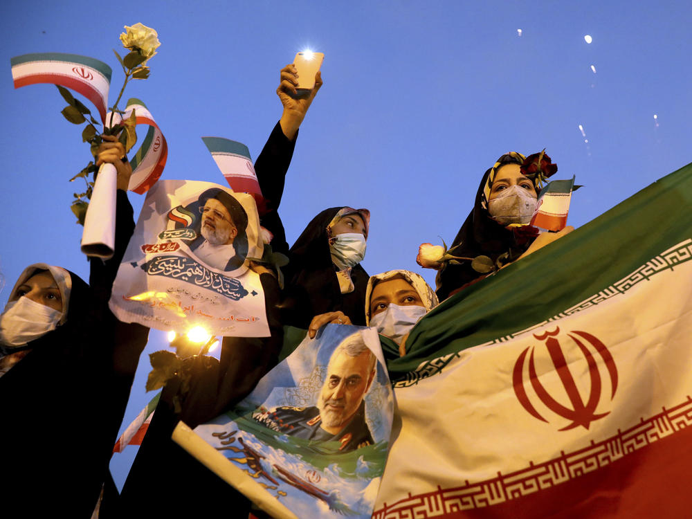 Supporters of Iranian President-elect Ebrahim Raisi celebrate in Tehran on Saturday after he won the presidential election.