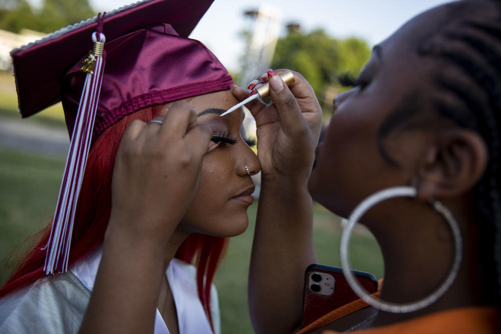 Washington Latin senior Sarah Ce'Taya Hamlett holds still as her cousin, Gina Williams, helps her with her lashes.