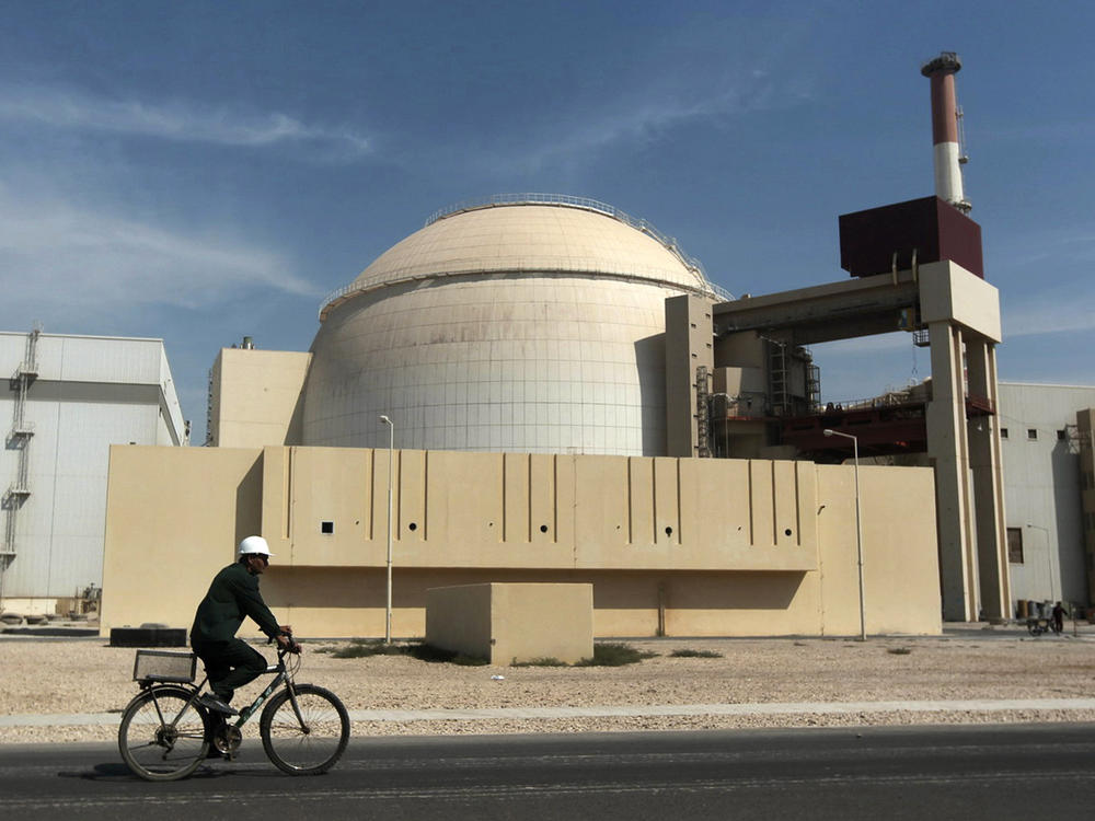 In this 2010 file photo, a worker rides a bicycle in front of the reactor building of the Bushehr nuclear power plant, just outside the southern city of Bushehr. Iran's sole nuclear power plant has undergone a temporary emergency shutdown, state TV reported on Sunday.