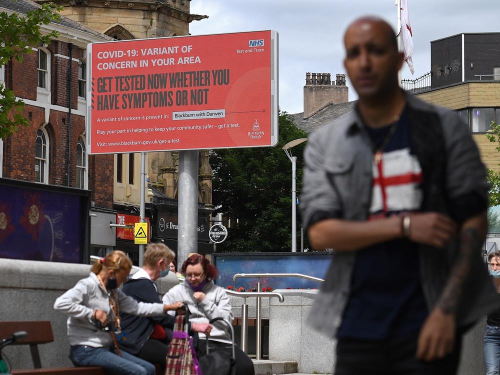 A sign urges people to get tested for a COVID-19 variant in Blackburn, England. The U.K. is experiencing a surge in the delta variant, which was first identified in India.