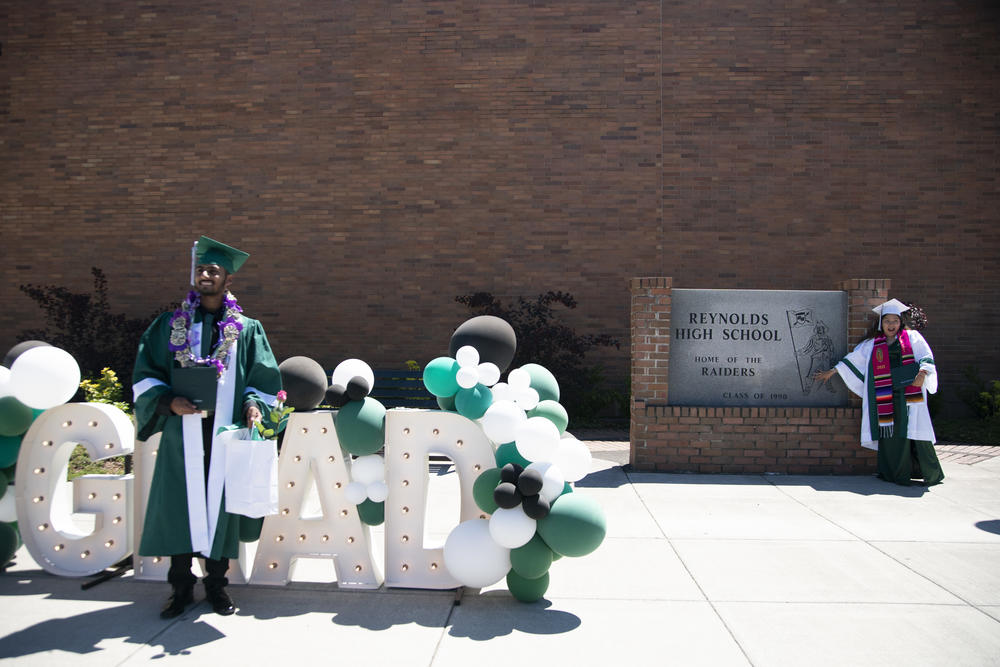 Students pose for pictures on graduation day at Reynolds High School in Troutdale, Ore.