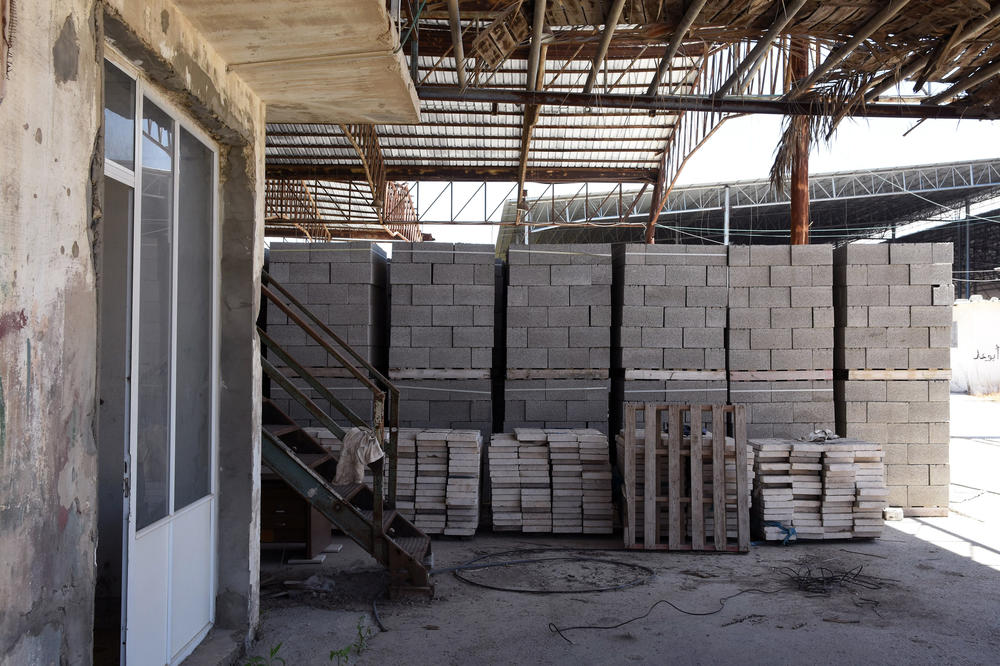The blocks at Shawa's warehouse are manufactured with GRM cement so they can only be sold to a project approved by the mechanism, and United Nations observers come a few times a month to make sure they haven't been sold on the black market. They have long been sitting unused in this warehouse.