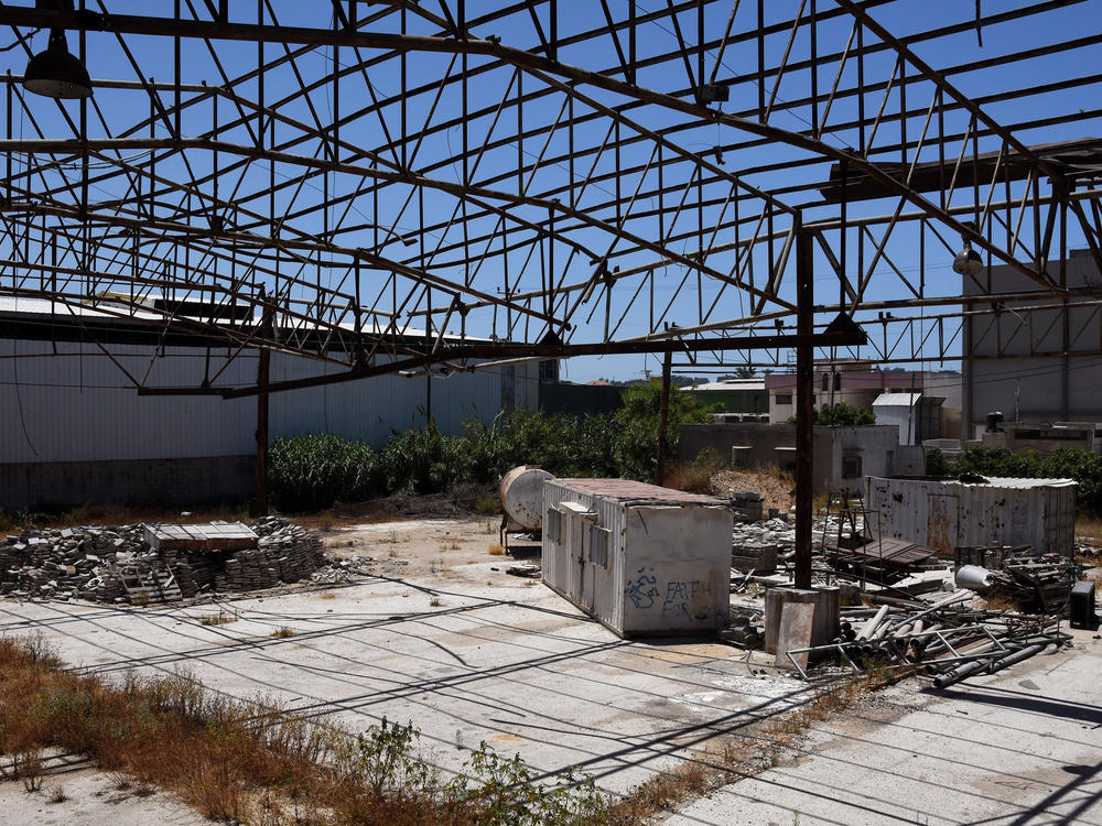 Faysal Shawa's warehouse was damaged in the 2014 conflict. Shawa and employees maintain no connection to Hamas.