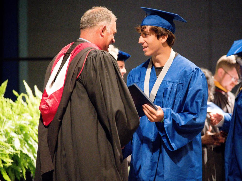 Matanzas High School Principal Jeff Reaves shakes a student's hand on graduation day. Reaves handwrote 459 notes to the graduating class of 2021 to celebrate their accomplishments.