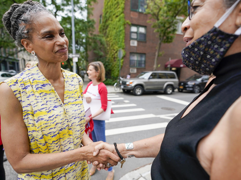 Democratic mayoral candidate Maya Wiley (left) greets a voter during a campaign stop Tuesday near a polling place in New York's West Village.