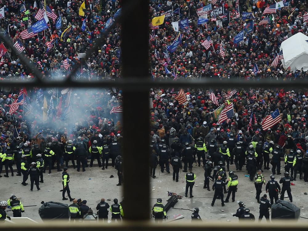 Police hold back rioters gathered outside the U.S. Capitol on Jan. 6. New body camera footage released by the Justice Department shows the violence of that day from the perspective of the officers themselves.