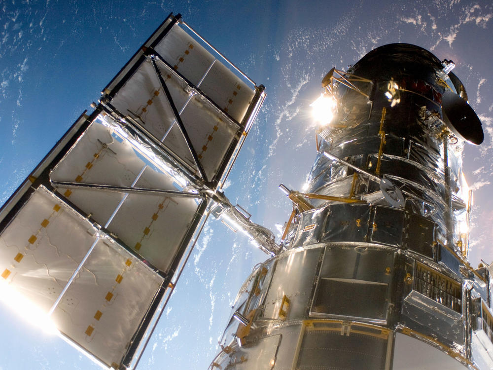 In this handout from NASA, the Hubble Space Telescope is grappled to Space Shuttle Atlantis STS-125 by the shuttle's Canadian-built remote manipulator system May 13, 2009 in Space.