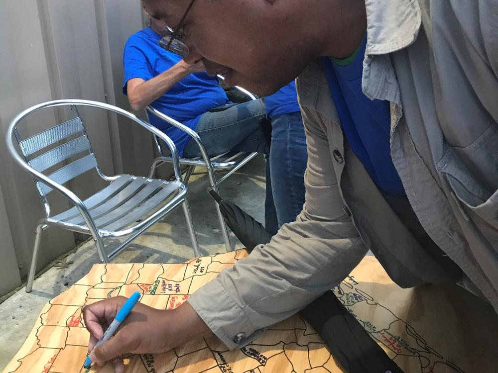 Marcellus Cadd signing his name in Round Rock, Texas, after finding a cache in all 254 counties in the state.