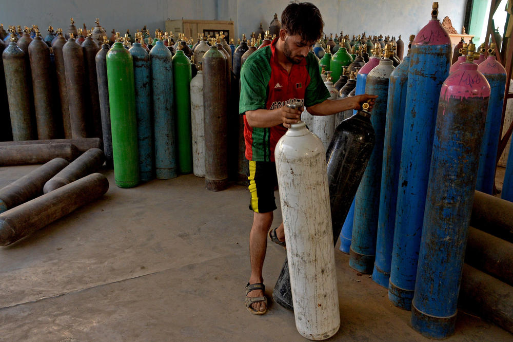 A worker at a Jalalabad facility that refills oxygen cylinders for medical use. The third wave of COVID-19 in Afghanistan has increased the number of patients in need of oxygen.