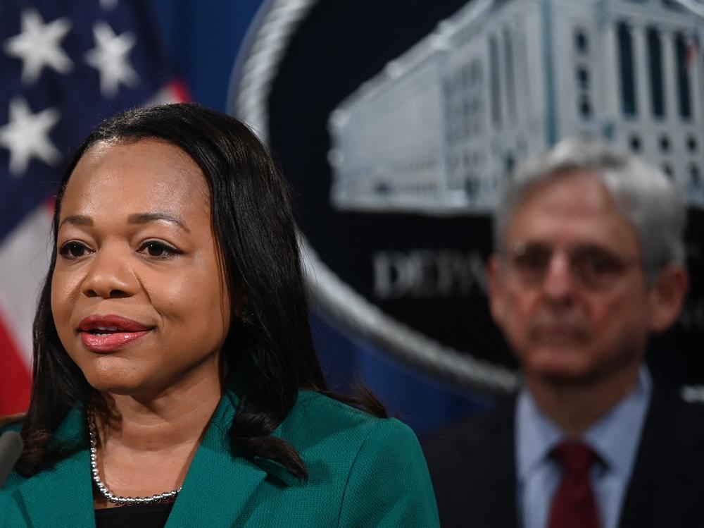Assistant Attorney General Kristen Clarke for the Justice Department's Civil Rights Division speaks during a news conference Friday announcing a lawsuit against the state of Georgia for its new voting law. Attorney General Merrick Garland is at right.
