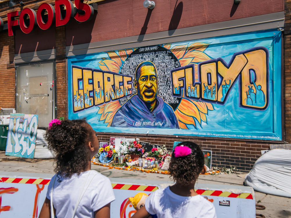 Jordan and Royal Pacheco view a mural of Floyd on Friday in Minneapolis ahead of Chauvin's sentencing.
