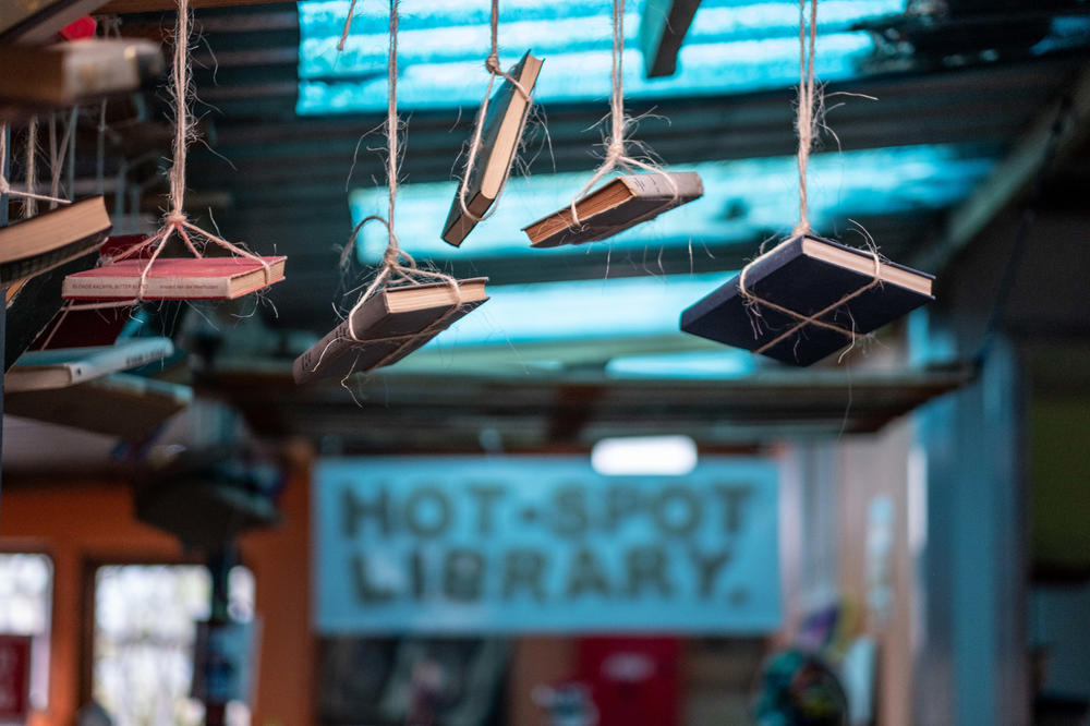 Decorative books hang from the ceiling in the Hot Spot Library.