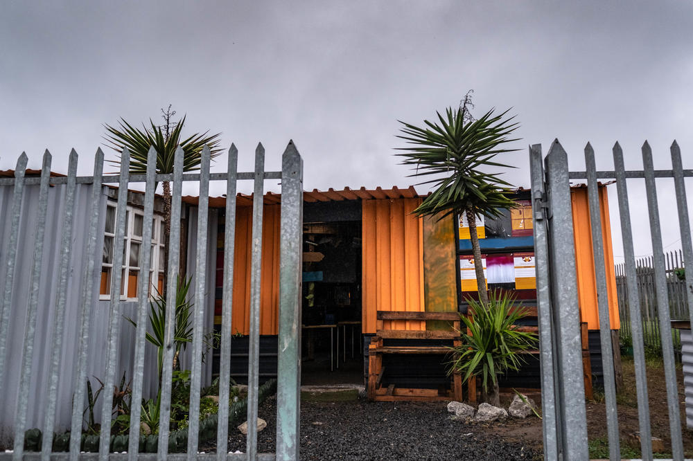 The Hot-Spot Library is made of used shipping containers connected by wood and metal. It sits between two gang territories.
