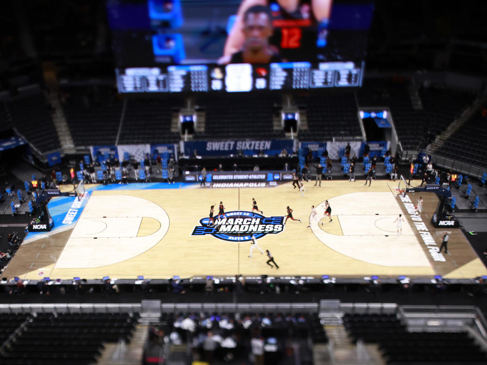 The March Madness logo on the court during the Sweet Sixteen round of the 2021 NCAA Men's Basketball Tournament in Indianapolis. Soon, some college athletes can get money when using their name, image or likeness.