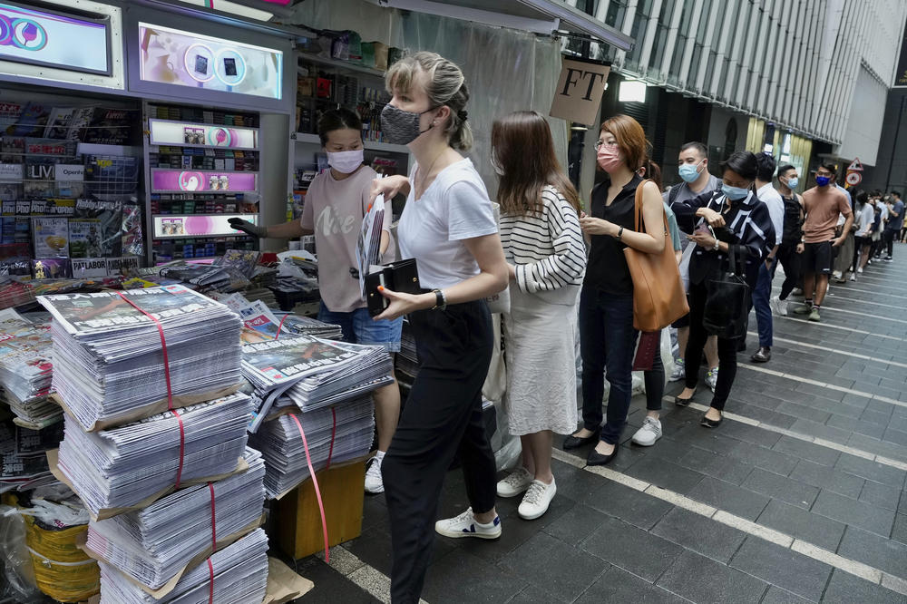 People line up for last issue of <em>Apple Daily</em> at a newsstand in downtown Hong Kong, on June 24.
