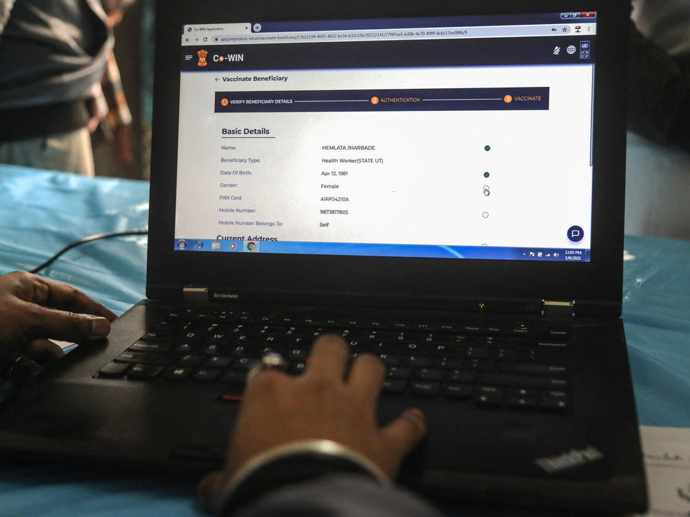 A health official checks data on the Indian government's Co-WIN website.