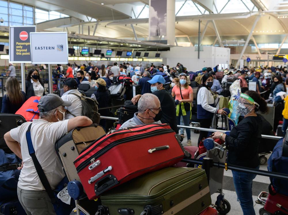 Travelers wait in line at John F. Kennedy Airport in New York City ahead of Memorial Day weekend on May 28.