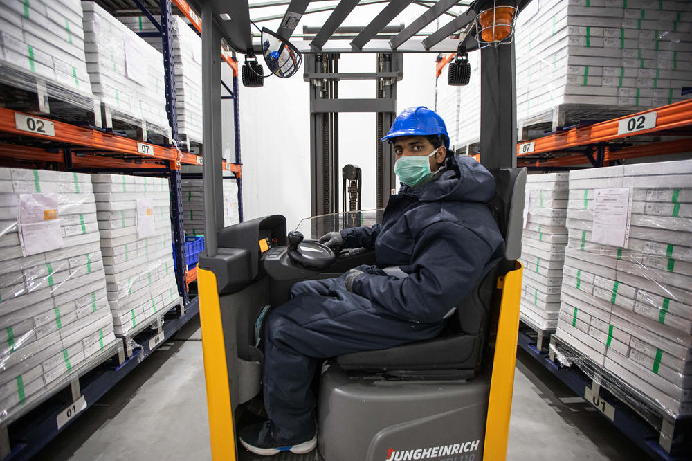 A worker surrounded by boxes of vaccines in the cold storage unit of the Serum Institute of India. In addition to manufacturing the AstraZeneca coronavirus vaccine, the institute produces vaccines for measles, tetanus and many other diseases. But the supply of COVID vaccines for India — and COVAX, the global vaccine program — has been problematic.