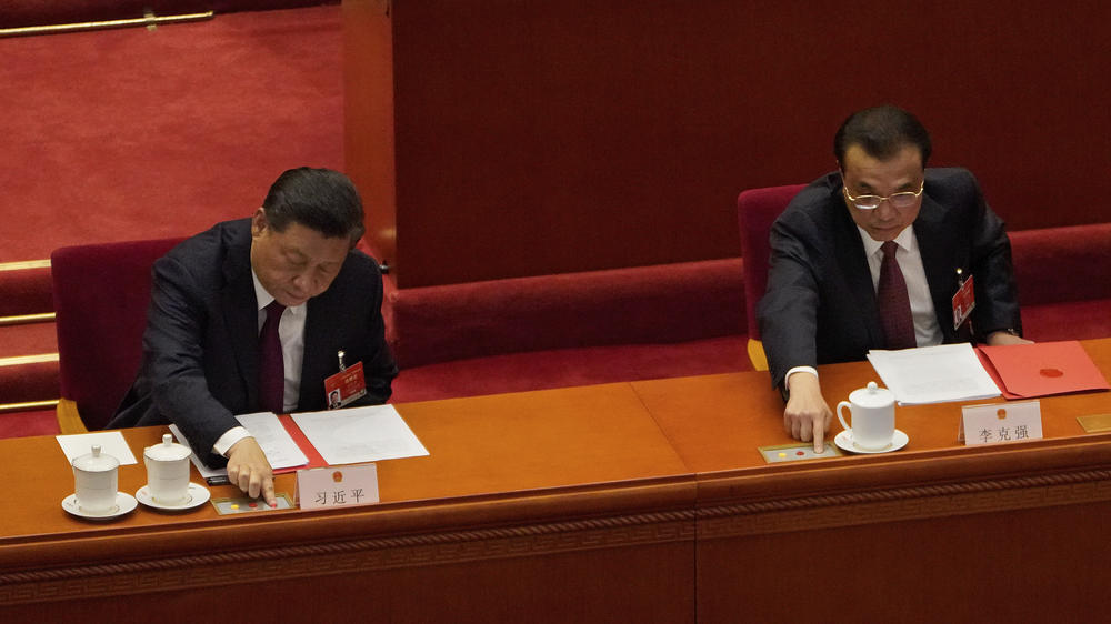 Chinese President Xi Jinping (left) and his Premier Li Keqiang cast their vote during the closing session of the National People's Congress at the Great Hall of the People in Beijing, on March 11. China's ceremonial legislature endorsed the ruling Communist Party's move to tighten control over Hong Kong by reducing the role of its public in picking the territory's leaders.