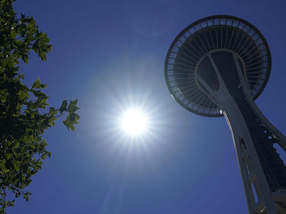 The sun shines near the Space Needle, Monday, June 28, 2021, in Seattle. Seattle and other cities broke all-time heat records over the weekend, with temperatures soaring well above 100 degrees.