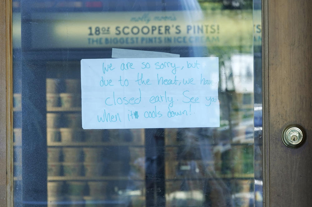 A sign is shown on the door of a Molly Moon's Ice Cream store in Seattle's Capitol Hill neighborhood. The store was closed Monday due to excessive heat.