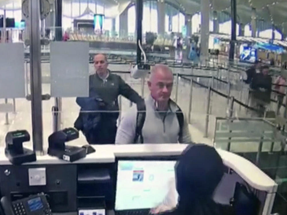 This Dec. 30, 2019 image from security camera video shows Michael L. Taylor, center, and George-Antoine Zayek at passport control at Istanbul Airport in Turkey. Taylor and his son Peter, are charged in Japan with helping Nissan's former chairman, Carlos Ghosn, jump bail and escape Japan for Lebanon.