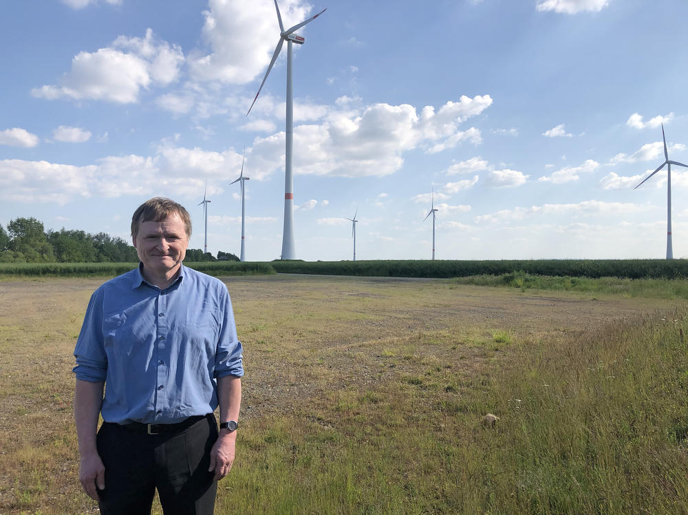 Guido Steffen, spokesman for RWE, stands among his company's wind turbines, constructed atop a filled section of one of the company's mines. RWE is receiving billions of euros worth of government subsidies to transition away from coal.