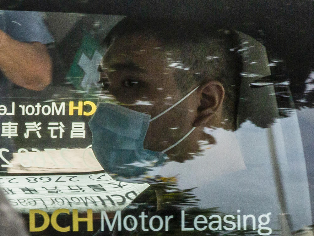 Tong Ying-kit, who is accused of deliberately driving his motorcycle into a group of police officers, arrives at the West Kowloon court in Hong Kong on July 6, 2020. Accused of terrorism and inciting secession, Tong became the first person in Hong Kong to be charged under China's sweeping national security law.