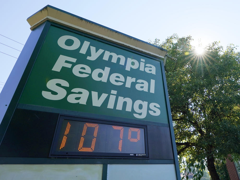 A display at an Olympia Federal Savings branch shows a temperature of 107 degrees Fahrenheit on Monday in the early evening in Olympia, Wash.