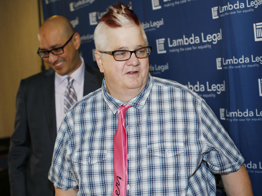 Dana Zzyym, seen here at right in 2015, has been suing the State Department, seeking more gender options for passports. The State Department announced Wednesday it will add an option besides male or female.