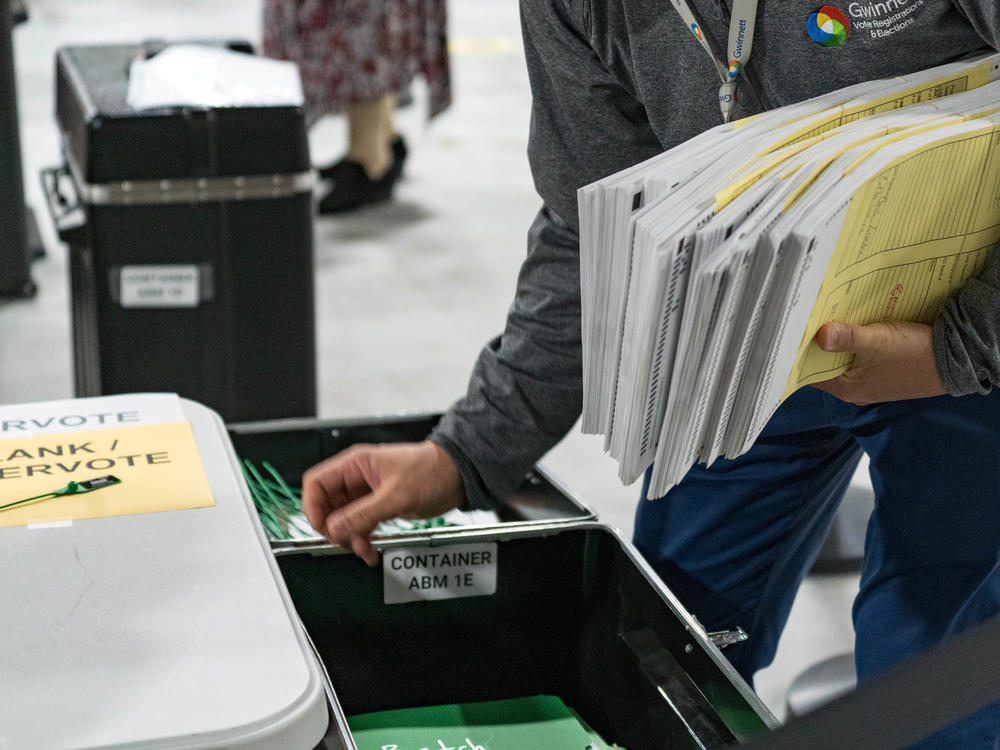Georgia election workers begin their recount of ballots after the November election. Despite three recounts of the tally, former President Donald Trump and his allies falsely claim electoral fraud cost him the state.