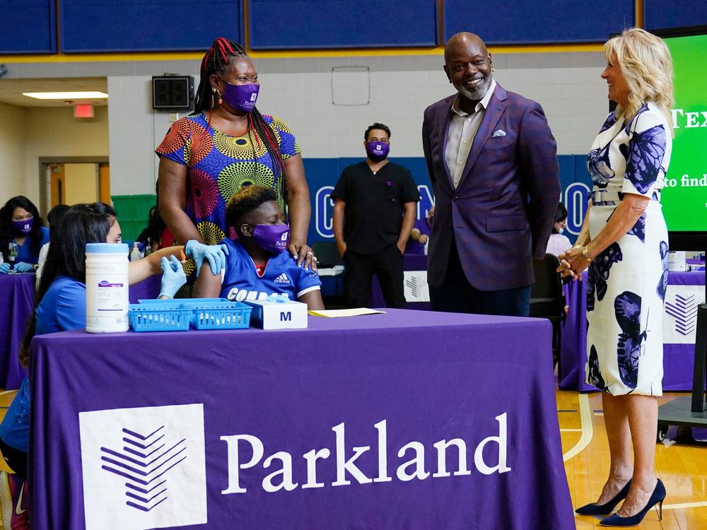 First lady Jill Biden and former Dallas Cowboy and Football Hall of Famer Emmitt Smith tour a vaccination site in Dallas.