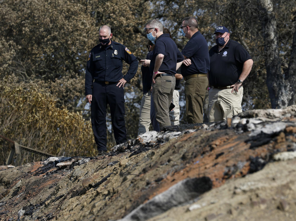 Cal Fire firefighters and FEMA officials survey the fire damage at Lake Berryessa, Calif., on Aug. 31, 2020, after the LNU Lightning Complex Fire.