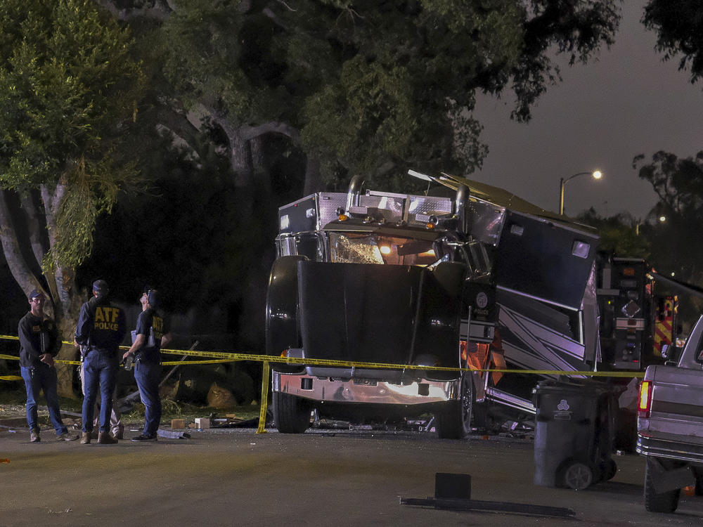 A cache of 5,000 pounds of illegal fireworks seized at a South Los Angeles home exploded and destroyed an armored Los Angeles Police Department tractor-trailer, damaging nearby homes and cars and causing injuries, authorities said.