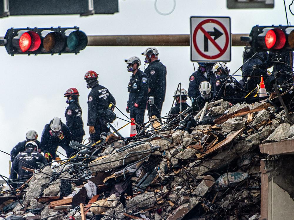 Search and rescue teams look for possible survivors in the partially collapsed 12-story Champlain Towers South condo building on Wednesday in Surfside, Fla.
