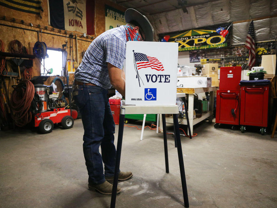 A voter marks his ballot at a polling place on Nov. 3 in Richland, Iowa. A new poll finds ensuring access to voting is more important than tamping down on voter fraud for most Americans.