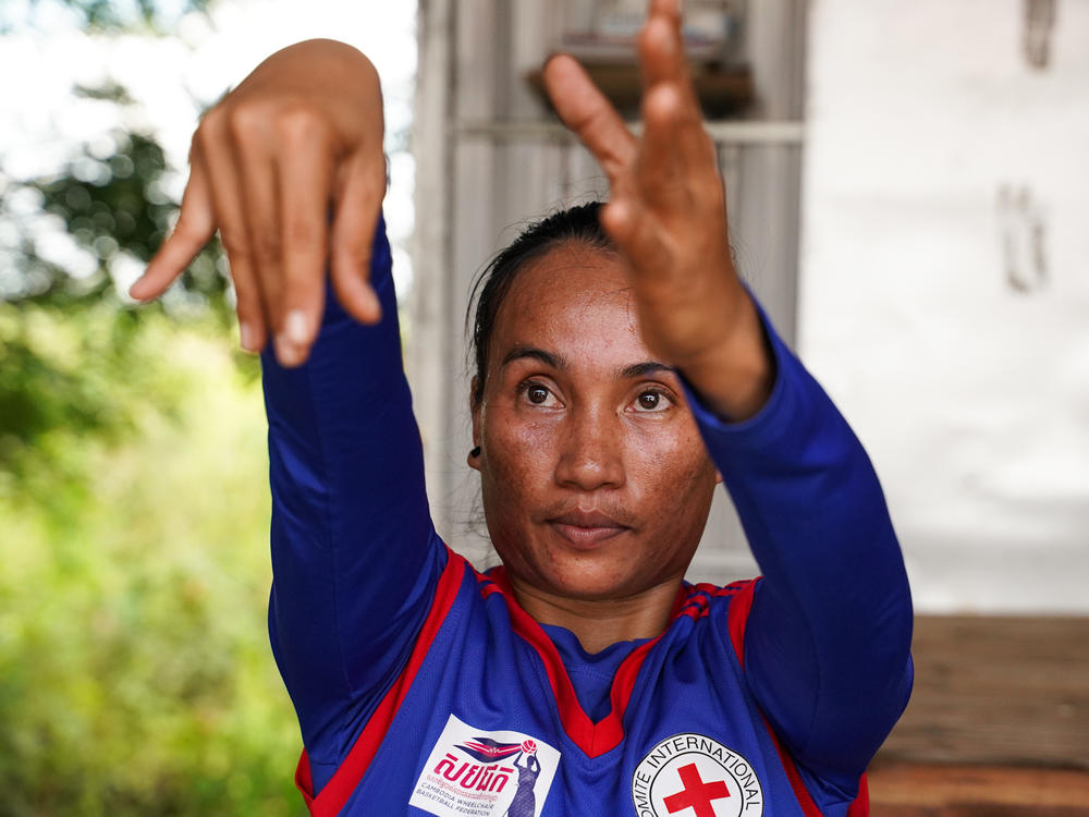 Sinet An, who was born with a disability, is the star of Cambodia's women's wheelchair basketball team, which celebrated their first win in an international tournament just before the pandemic hit. With Cambodia in lockdown, she hones her skills in virtual practice sessions from her home in Chuuok village in Kandal province. Above: a practice session on June 24.