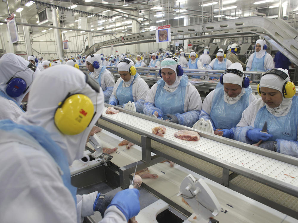 Workers prep poultry at the meatpacking company JBS in the Brazilian state of Paraná in 2017. A recent ransomware attack against JBS is raising concerns about cybersecurity at food companies.