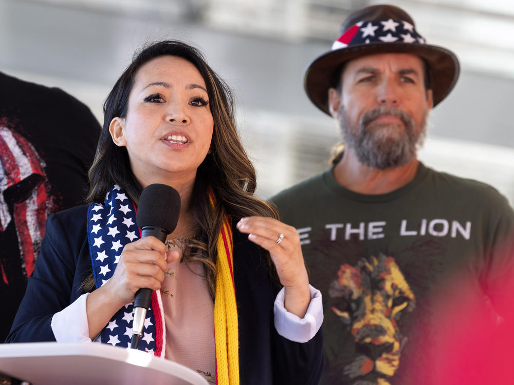 Amy Phan West, a candidate for Congress, speaks as event organizer Alan Hostetter listens during a pro-Trump rally in Santa Ana, Calif., on Nov. 9, 2020.