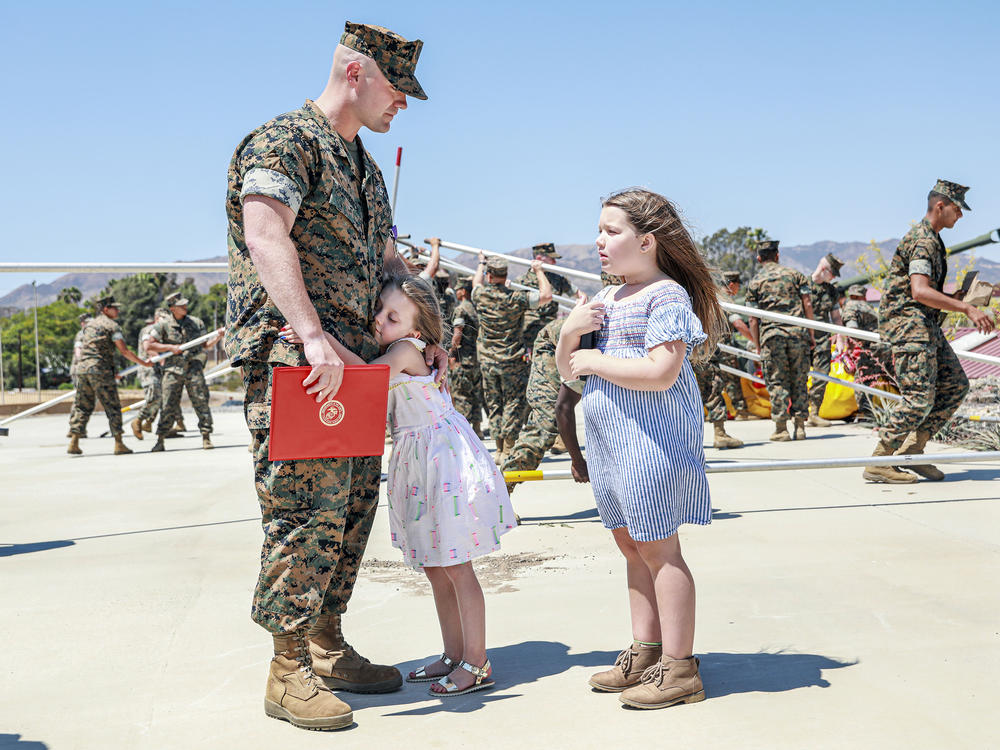 Joseph Hardebeck, a senior Navy corpsman, is greeted by his daughters Zoey, 9, and Adalie, 7, after receiving the Purple Heart at an award ceremony at Southern California's Camp Pendleton on Thursday.