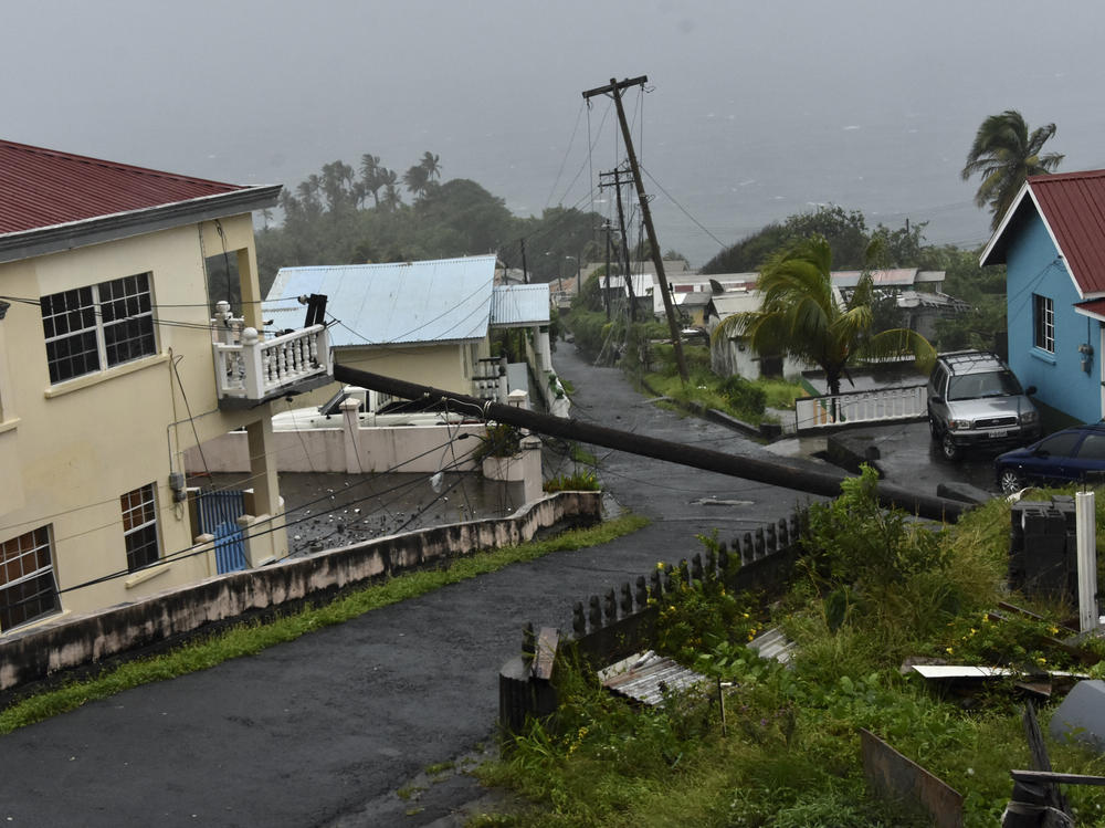 An electrical pole felled by Hurricane Elsa leans on the edge of a residential balcony, in Cedars, St. Vincent, on July 2, 2021.