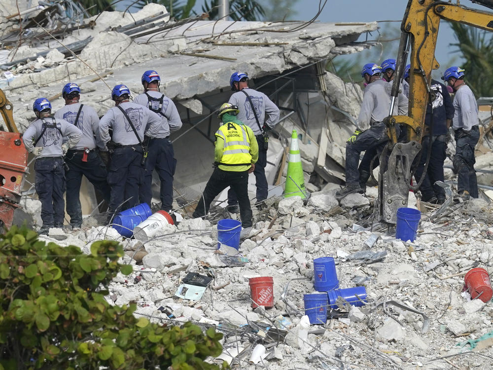 Rescue crews work at the site of the collapsed Champlain Towers South condo building on Monday after the remaining structure was demolished late Sunday.