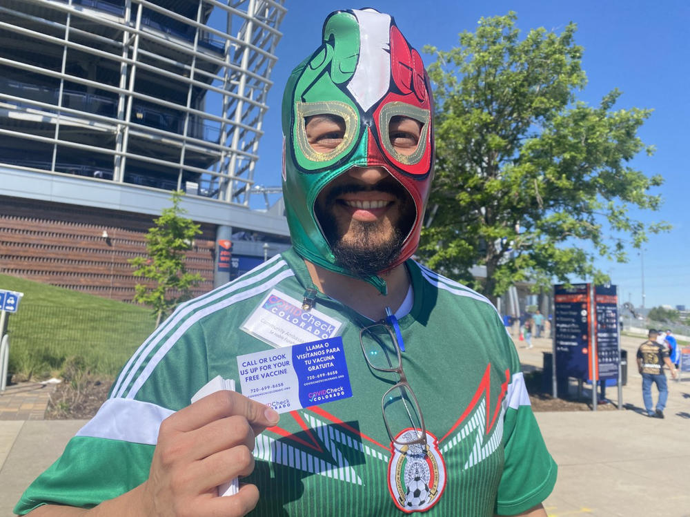 Jesus Romero Serrano, a community ambassador with the Denver mayor's office, at the CONCACAF Nations League soccer tournament in Denver. Serrano met with Latino soccer fans before the match, encouraging them to get vaccinated.