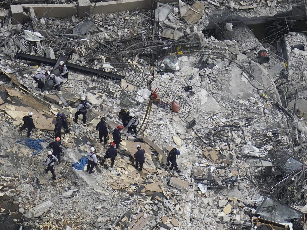 Rescue workers search in the rubble at the Champlain Towers South condo in Surfside, Fla., on June 26.