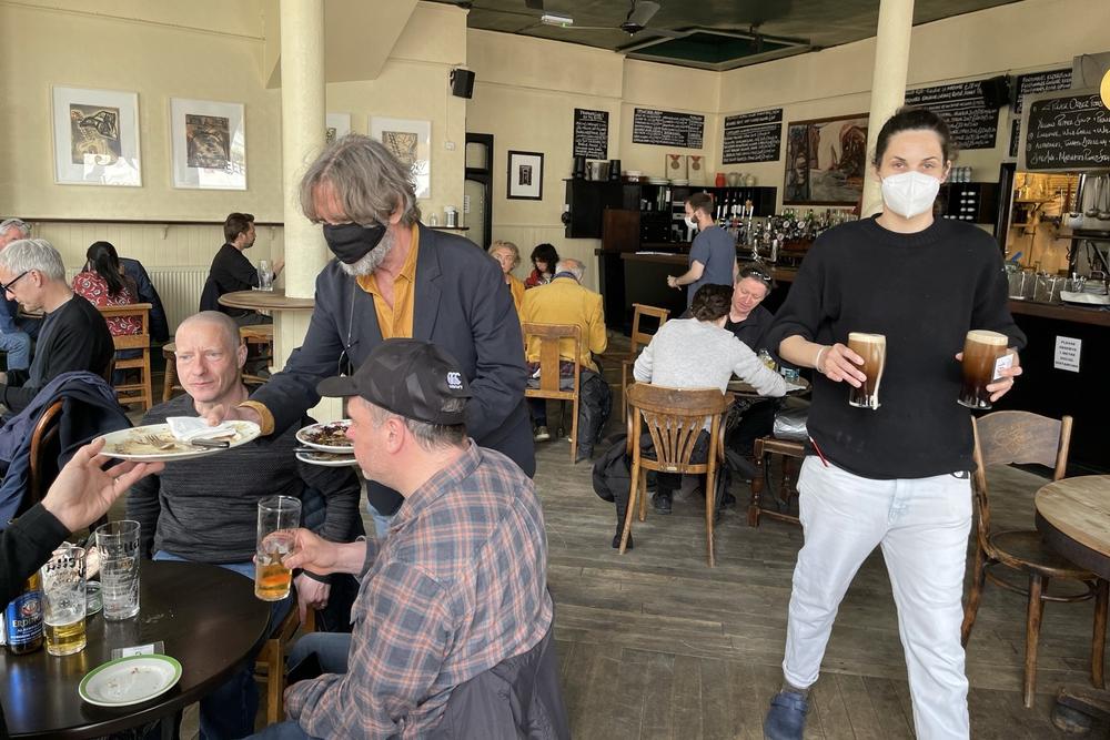Belben clears plates on the pub's reopening day in May after months of coronavirus lockdown.