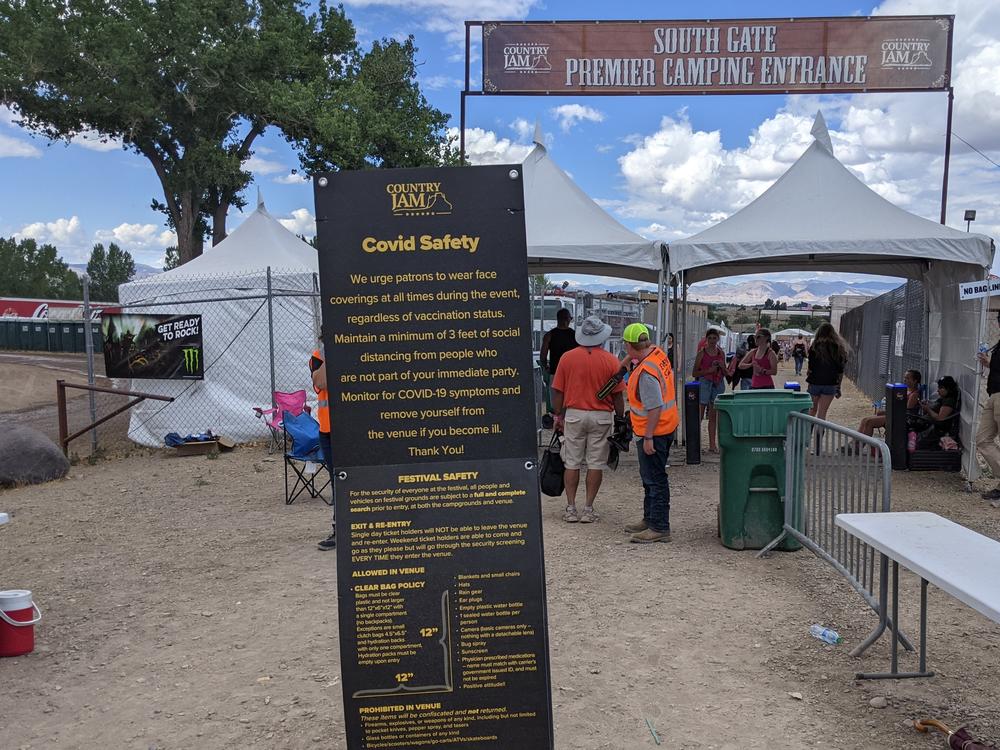 A sign urged Country Jam concertgoers to wear masks regardless of their vaccination status. Most did not.